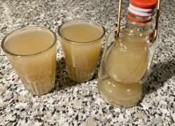 Hotový jablkovo-zázvorový shot naliaty v pohároch aj vo fľaške