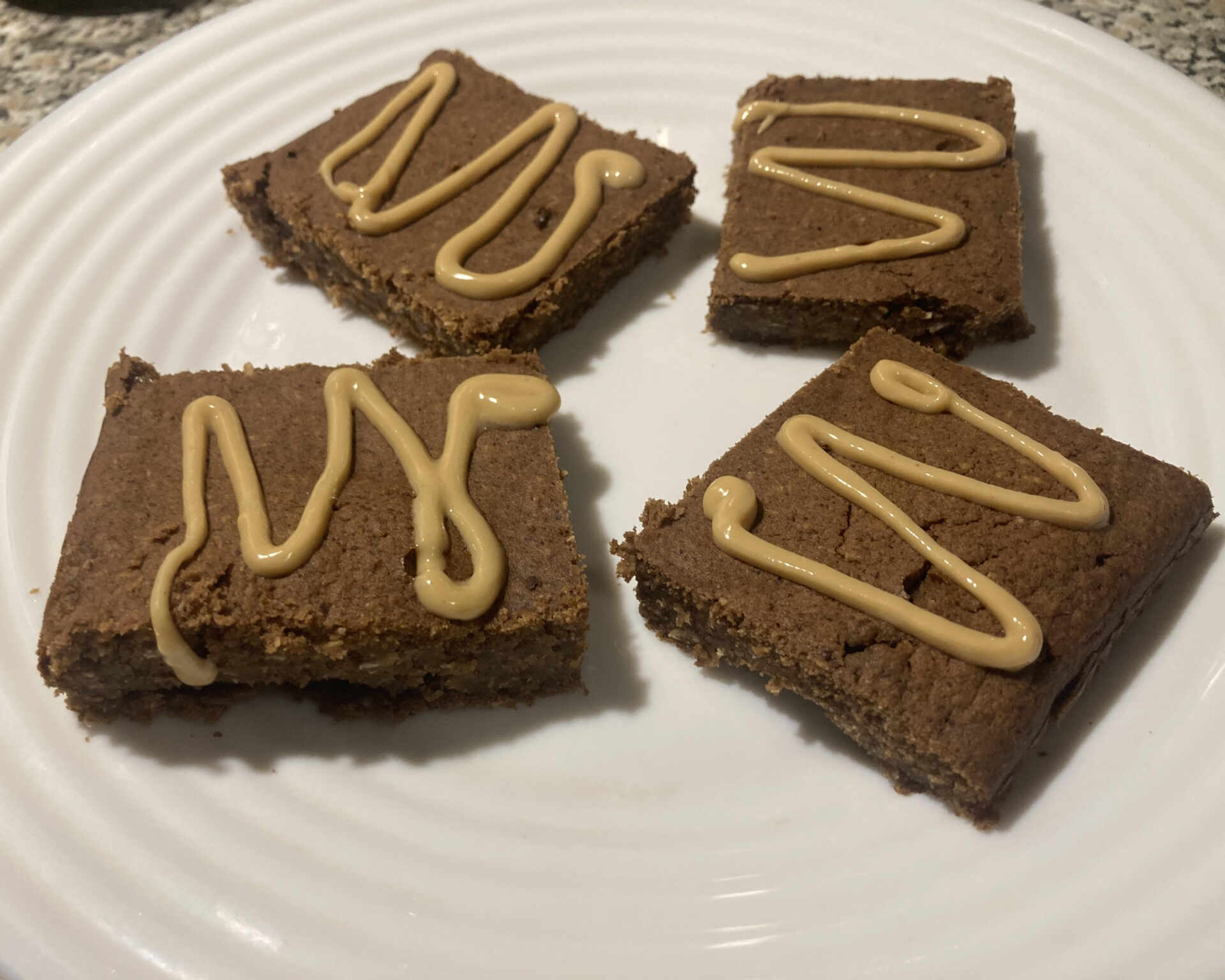 Hotové arašidové brownies ozdobené arašidovým maslom