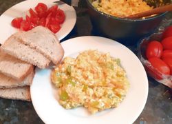 Miešané vajíčka na tanieriku s chlebom a cherry paradajkami